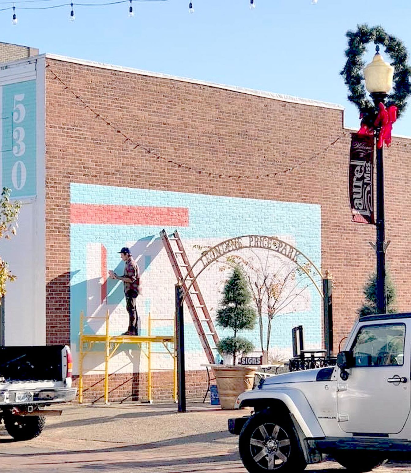 River Prince working on the mural at Leontyne Price Park at Christmastime. (Facebook).jpeg